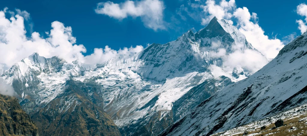 Majestic snow-capped peaks of Annapurna in clear daylight at Annapurna Base Camp